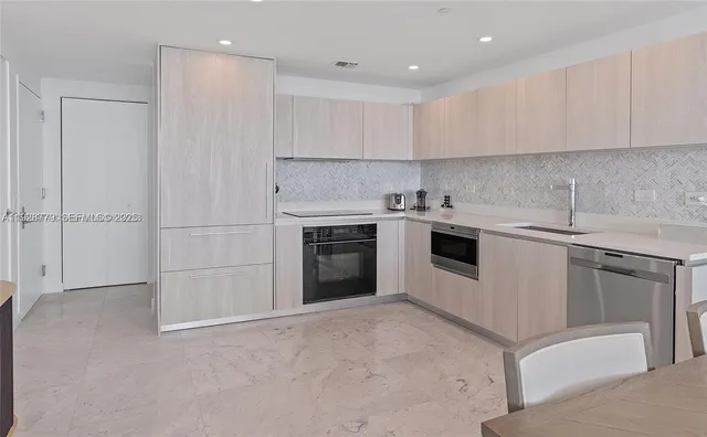 a kitchen with a sink cabinets and appliances