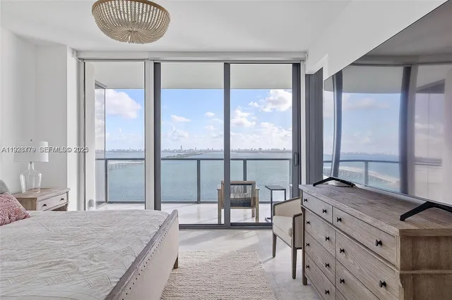 a bedroom with a large bed and a large window