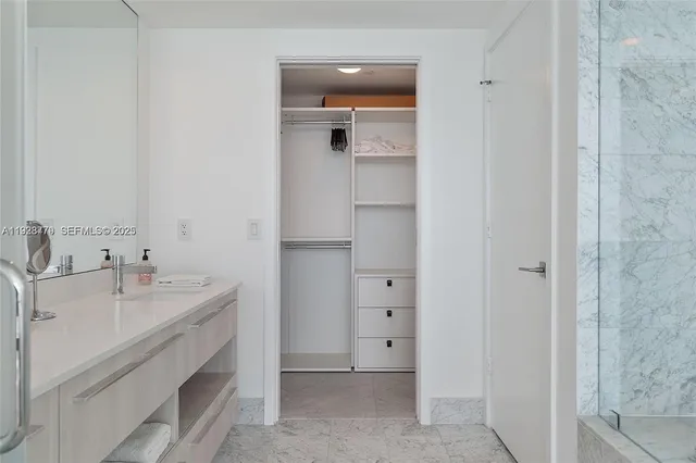 a bathroom with double vanity sink and a mirror