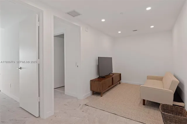 a bedroom with two large bed and a large window