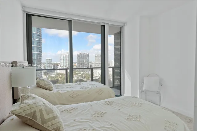 a bedroom with two beds and painted walls