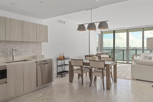 a kitchen with stainless steel appliances granite countertop a sink a stove a refrigerator and island