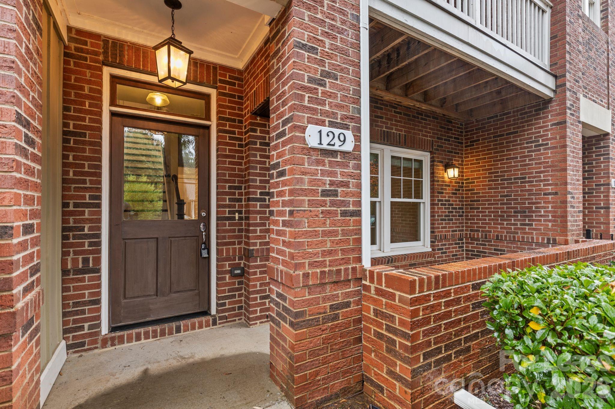 129 Grandin Road Charlotte, NC 28208 - Photo 1 of 26 a front view of a house with a glass door