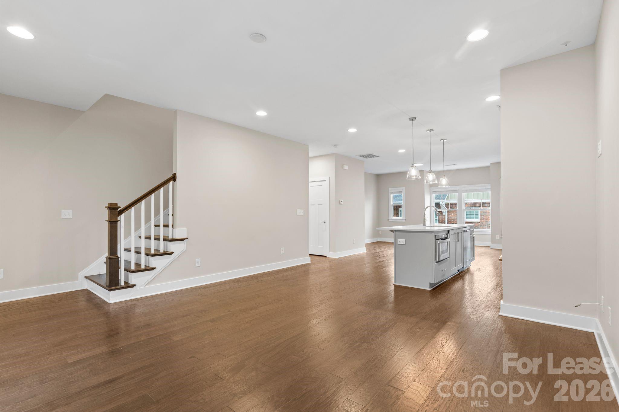 129 Grandin Road Charlotte, NC 28208 - Photo 12 of 26 a view of kitchen and an empty room with wooden floor