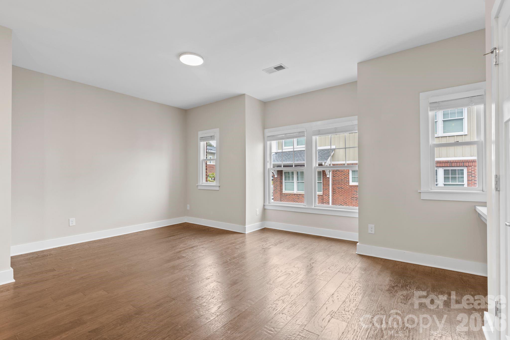 129 Grandin Road Charlotte, NC 28208 - Photo 13 of 26 a view of empty room with wooden floor and fan