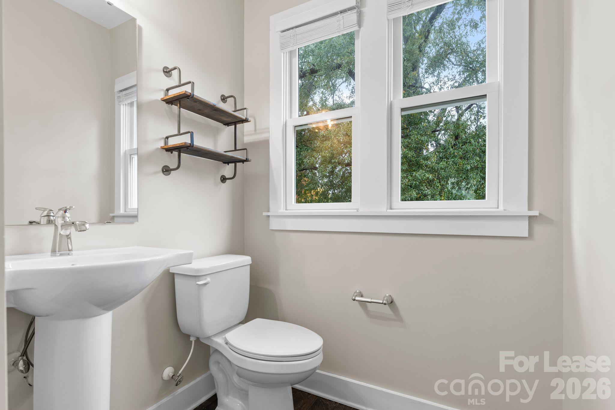 129 Grandin Road Charlotte, NC 28208 - Photo 14 of 26 a bathroom with a sink toilet and a mirror