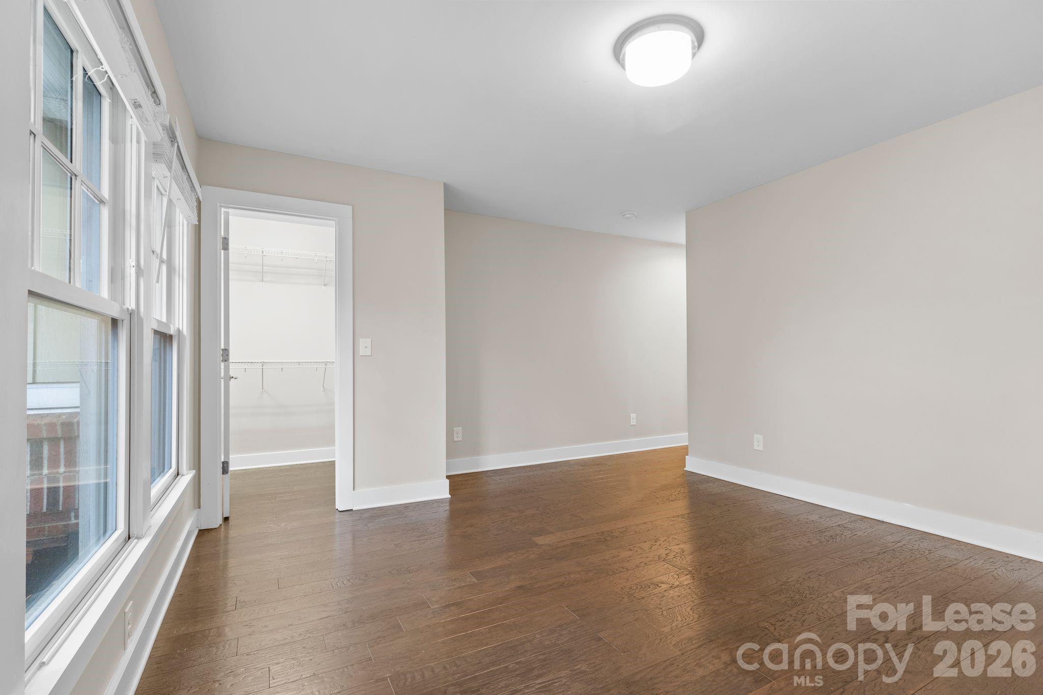 129 Grandin Road Charlotte, NC 28208 - Photo 17 of 26 an empty room with wooden floor and windows