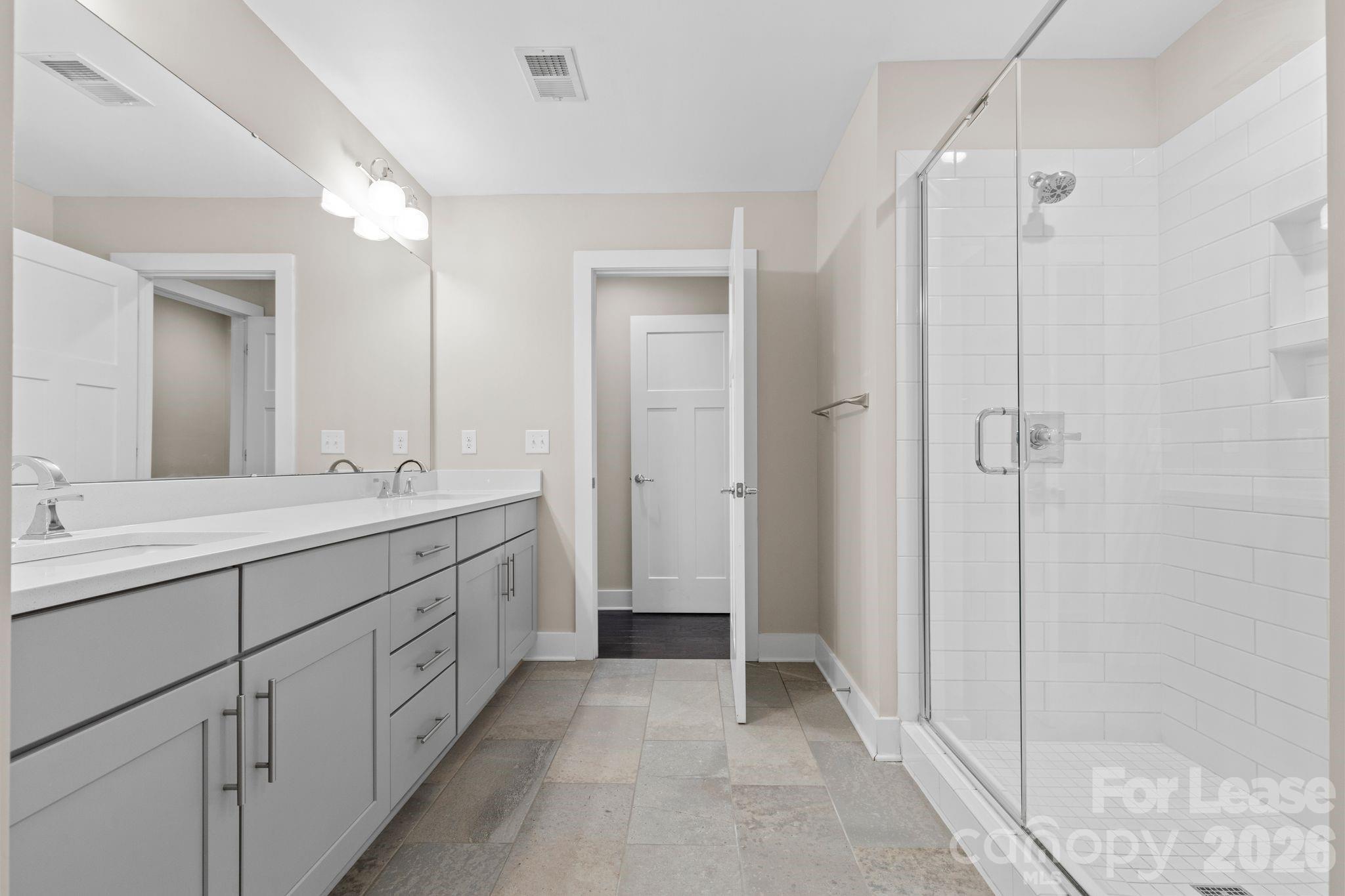 129 Grandin Road Charlotte, NC 28208 - Photo 19 of 26 a spacious bathroom with a shower sink and mirror