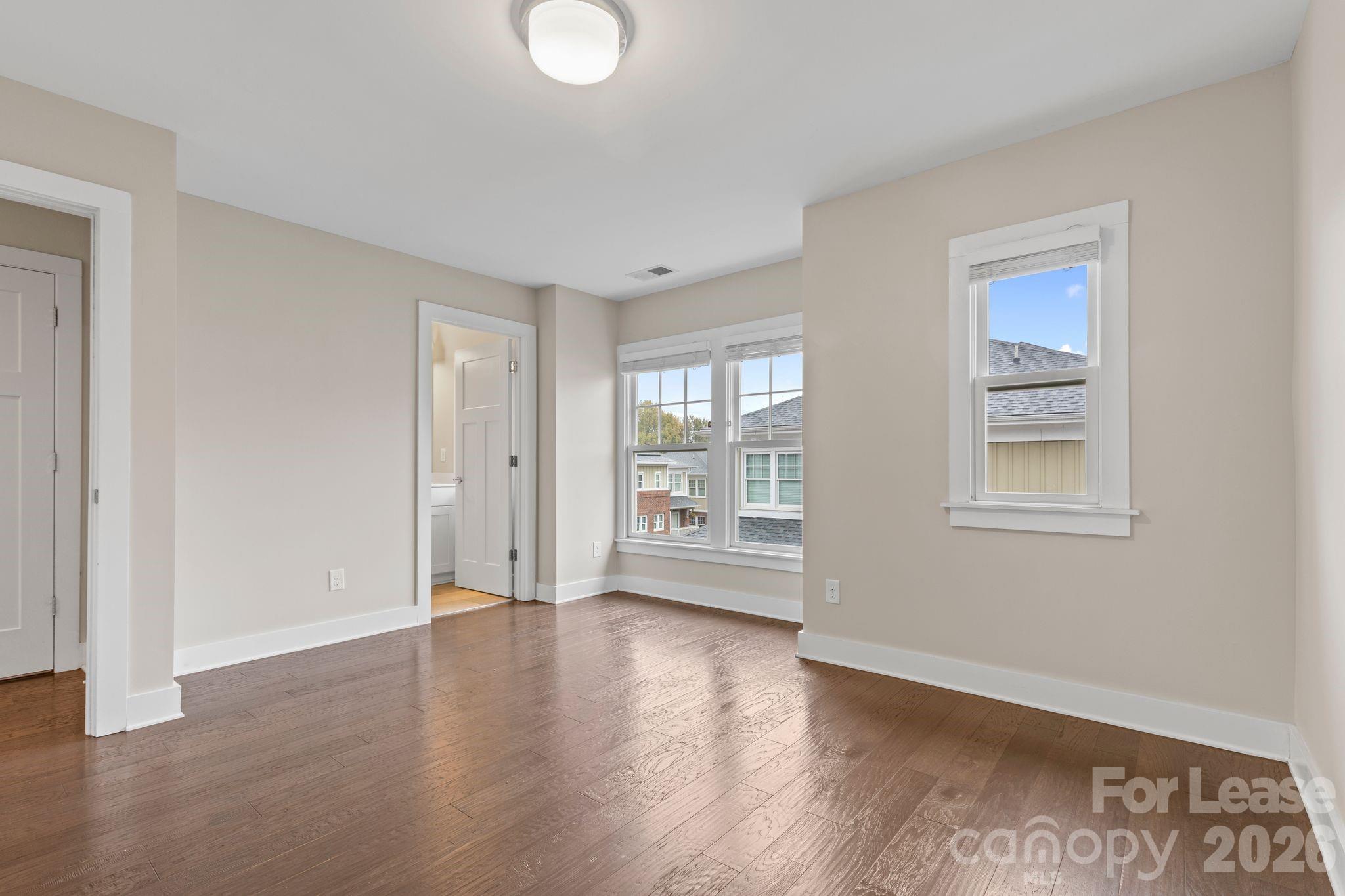 129 Grandin Road Charlotte, NC 28208 - Photo 22 of 26 a view of an empty room with wooden floor and a window