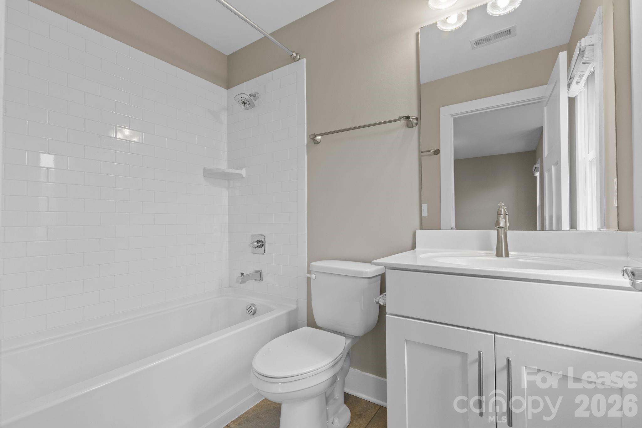 129 Grandin Road Charlotte, NC 28208 - Photo 23 of 26 a bathroom with a sink toilet vanity and shower