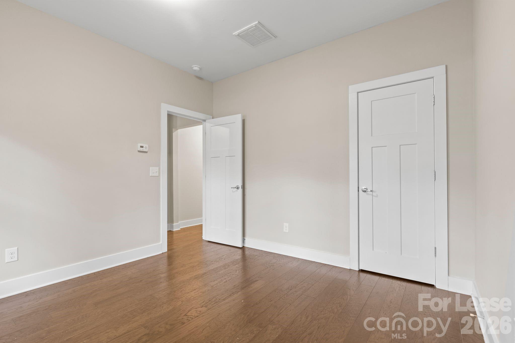 129 Grandin Road Charlotte, NC 28208 - Photo 4 of 26 a view of an empty room with wooden floor