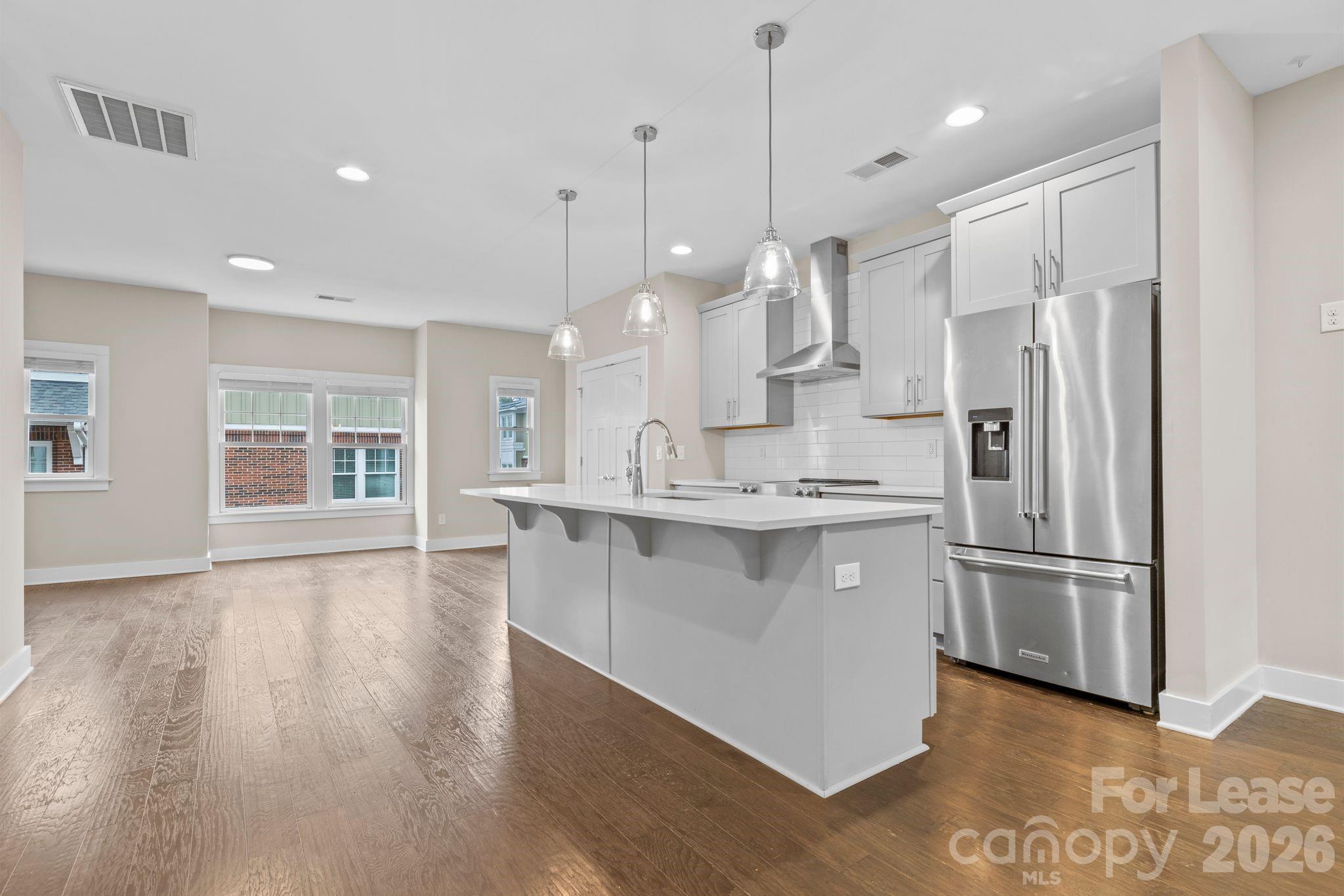 129 Grandin Road Charlotte, NC 28208 - Photo 7 of 26 a kitchen with stainless steel appliances granite countertop a refrigerator a sink dishwasher a oven and white cabinets with wooden floor