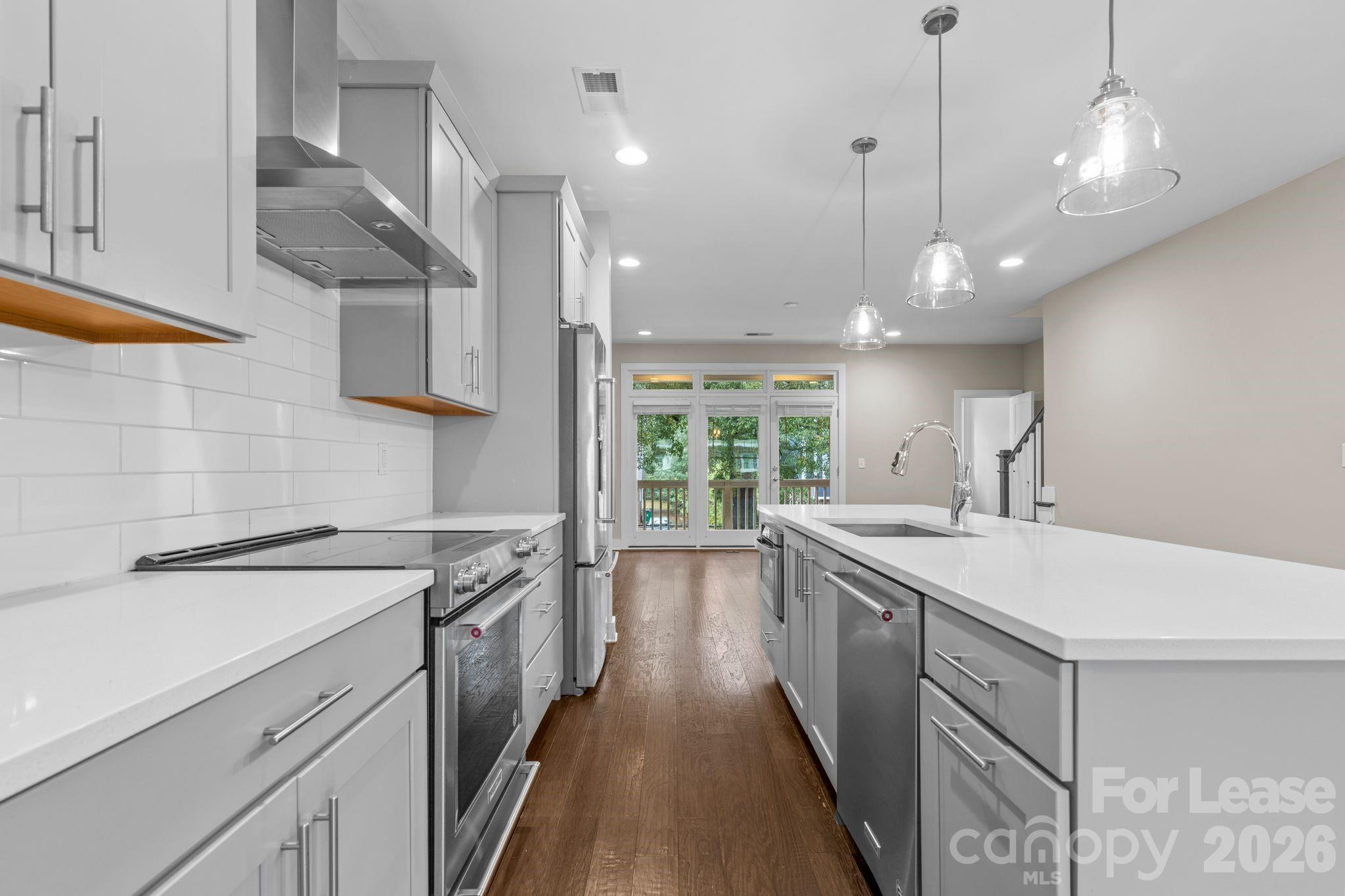 129 Grandin Road Charlotte, NC 28208 - Photo 9 of 26 a kitchen with a sink a stove and a refrigerator