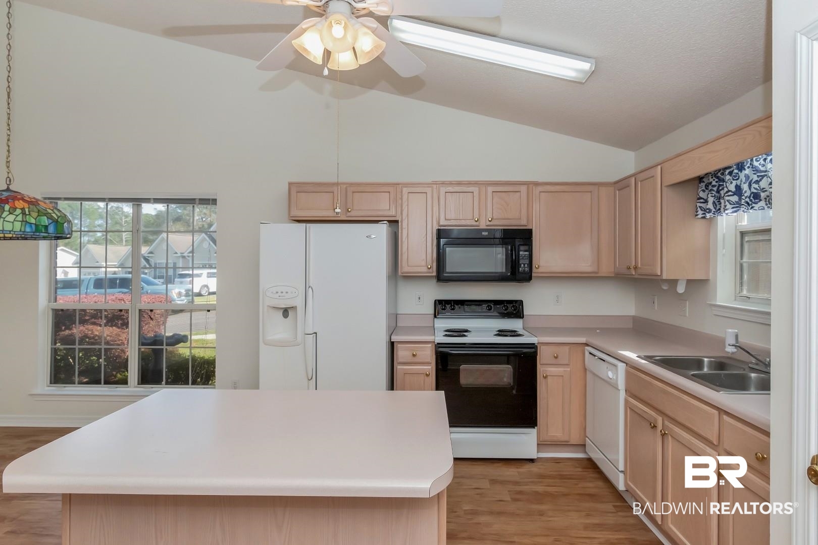 672 Spring Lake Drive East Mobile, AL 36695 - Photo 18 of 26 Kitchen featuring a sink, white appliances, light brown cabinets, and light countertops