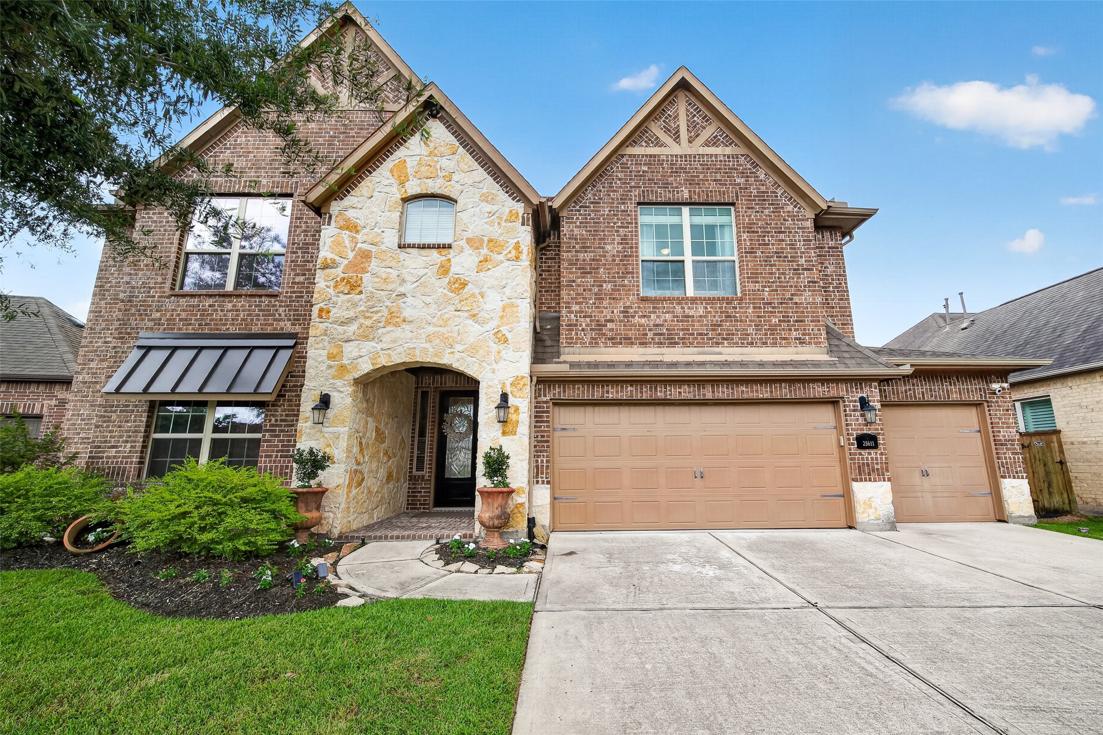 25611 Ellis Ridge Court Katy, TX 77494 - Photo 1 of 49 This is a two-story brick home with a stone accent facade and a three-car garage. It features a welcoming arched entryway, well-maintained landscaping, and a spacious driveway.