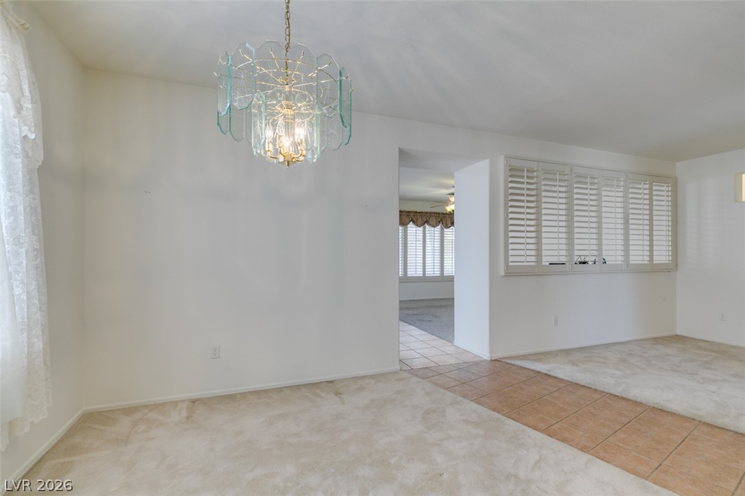 2189 Chapman Ranch Drive Henderson, NV 89012 - Photo 57 of 60 An open floor plan connects carpeted living areas with a tiled transition walkway.