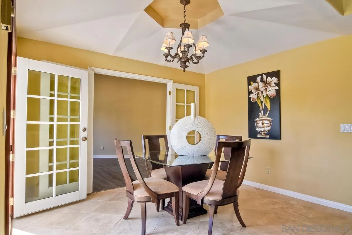 5460 La Crescenta Road Rancho Santa Fe, CA 92067 - Photo 11 of 27 a view of a dining room with furniture and chandelier