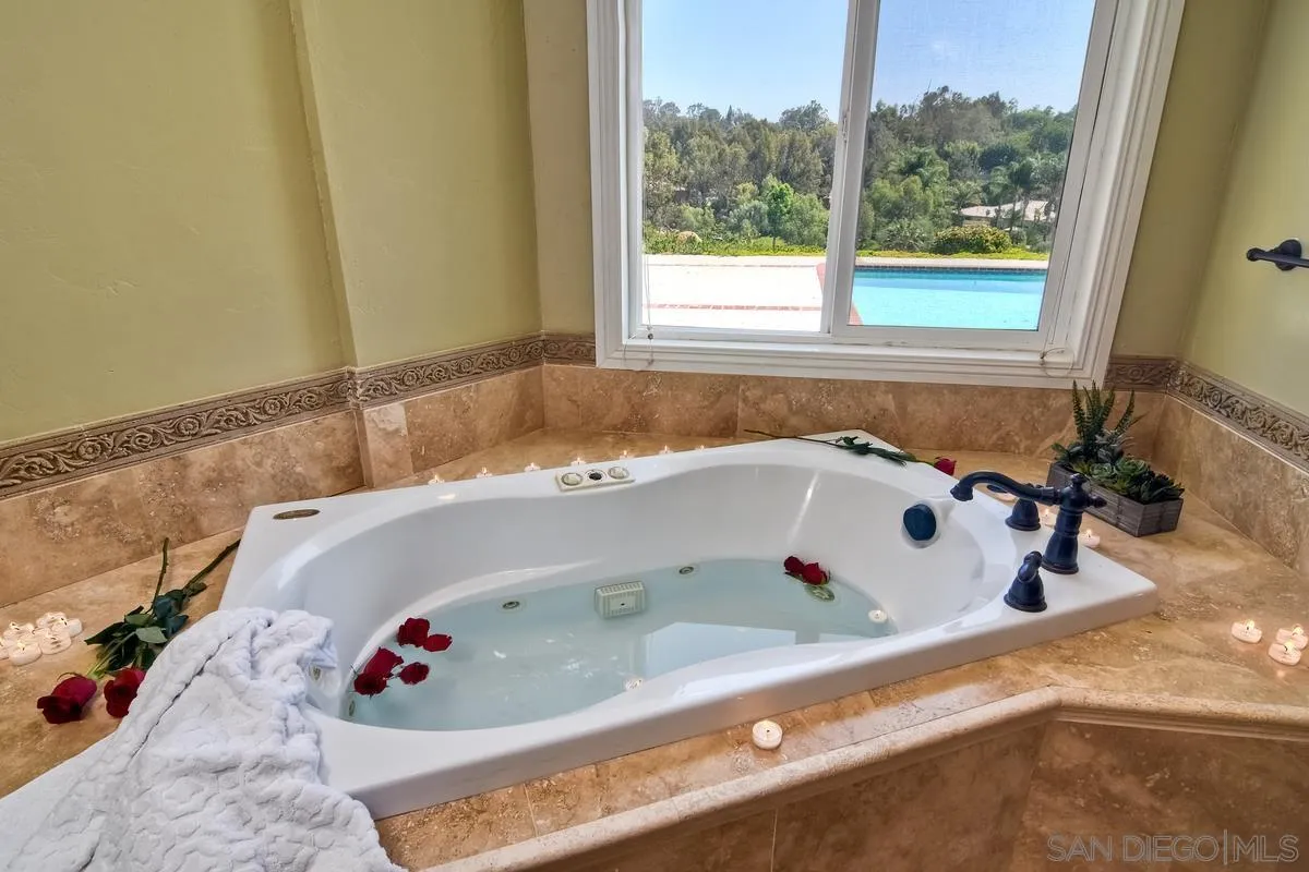 5460 La Crescenta Road Rancho Santa Fe, CA 92067 - Photo 22 of 27 a bath tub sitting in a bathroom next to a window
