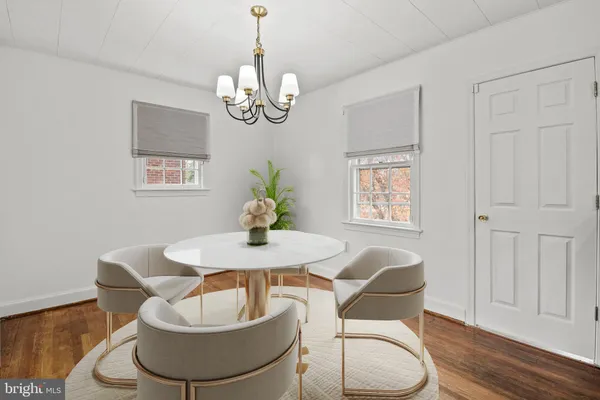 a view of a dining room with furniture wooden floor and chandelier