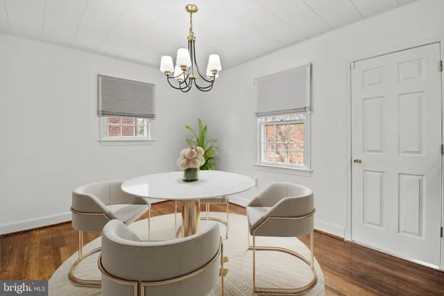 a view of a dining room with furniture wooden floor and chandelier