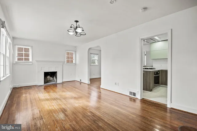 a view of a room with wooden floor and staircase