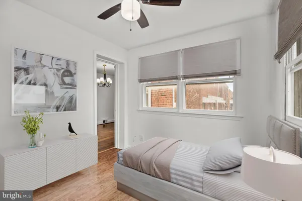 an empty room with a window and ceiling fan