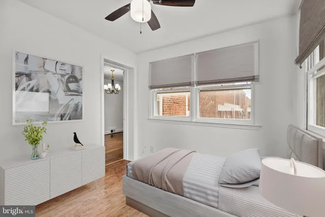 an empty room with a window and ceiling fan