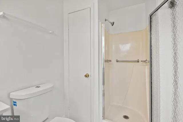 a bedroom with a bed and a wall painting