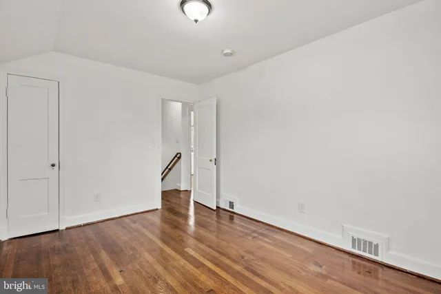 a living room with baby crib furniture and a window
