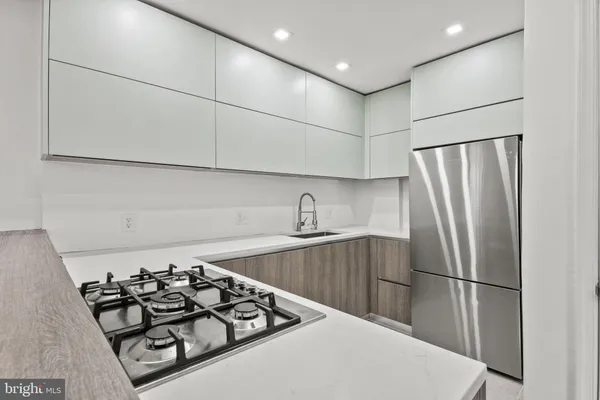 a kitchen with a sink stove and refrigerator