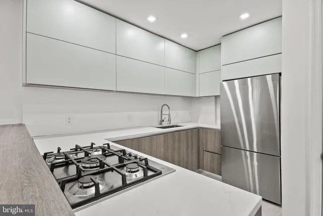 a kitchen with a sink stove and refrigerator