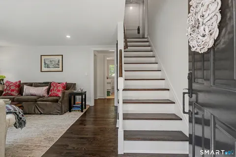a living room with furniture and stairs