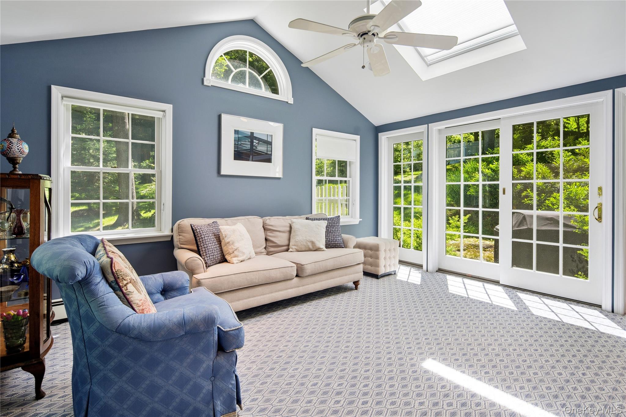 105 Cross Ridge Road Chappaqua, NY 10514 - Photo 23 of 43 Family room open to the kitchen features vaulted ceiling with skylight, demi-lune clerestory window, French doors with sidelights, ceiling fan, wool wall-to-wall carpet.