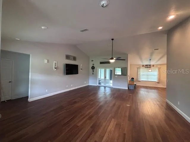 a view of empty room with wooden floor