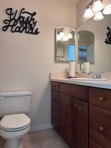 a bathroom with a sink vanity and toilet
