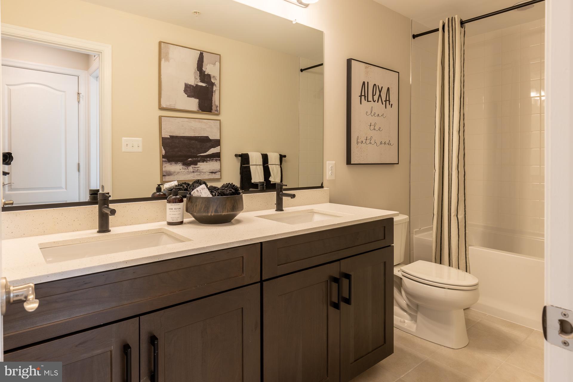 9990 B Justify Run Laurel, MD 20723 - Photo 11 of 13 a bathroom with a double vanity sink toilet and a mirror