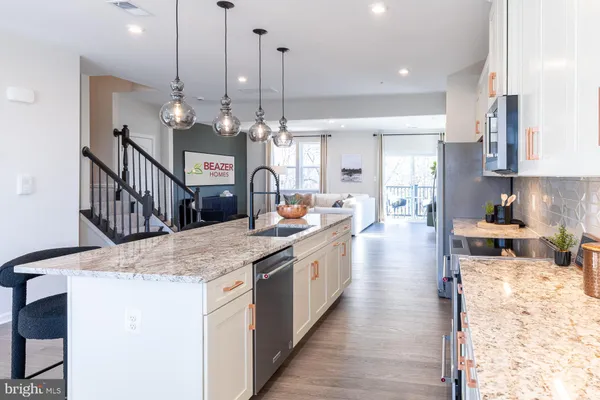 a large kitchen with kitchen island a stove a sink a dining table and chairs