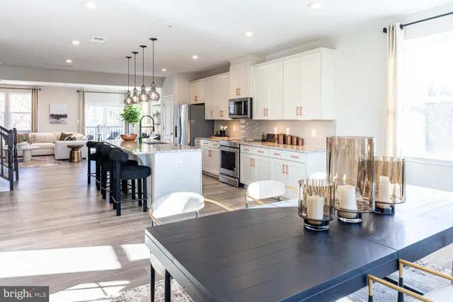 a living room with kitchen island furniture and a wooden floor
