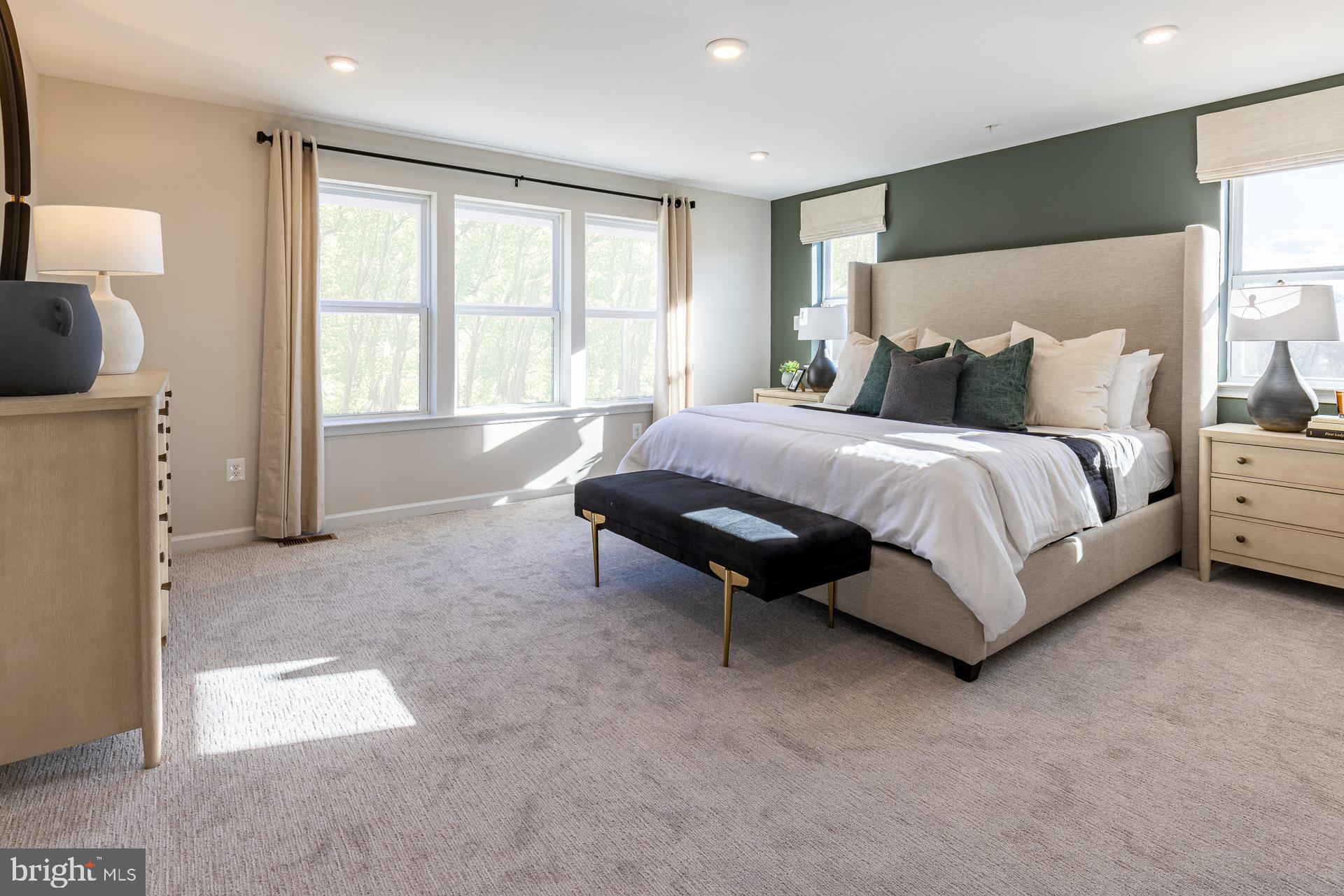 9990 B Justify Run Laurel, MD 20723 - Photo 8 of 13 a spacious bedroom with a bed and a lamp