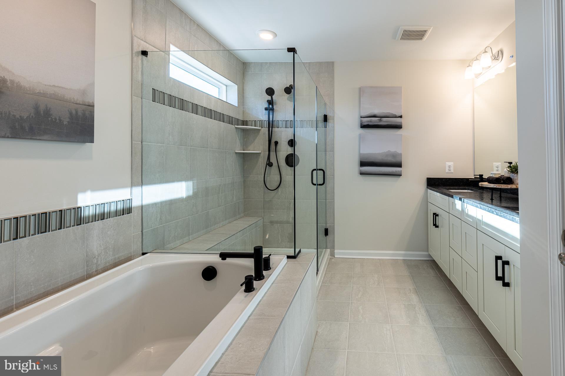 9990 B Justify Run Laurel, MD 20723 - Photo 9 of 13 a bathroom with a bathtub a sink a toilet and a shower