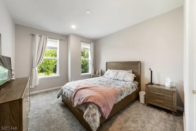 a large bed sitting in a bedroom next to a window
