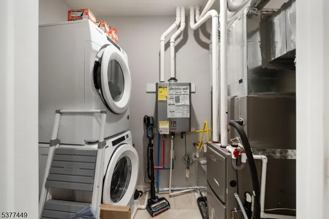 a view of a storage and utility room with washer and dryer