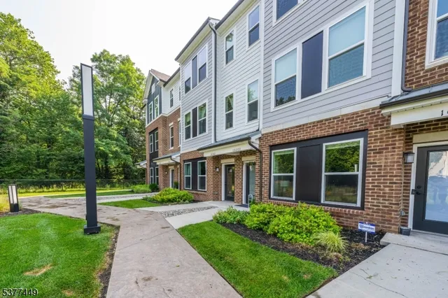 front view of a brick house with a yard