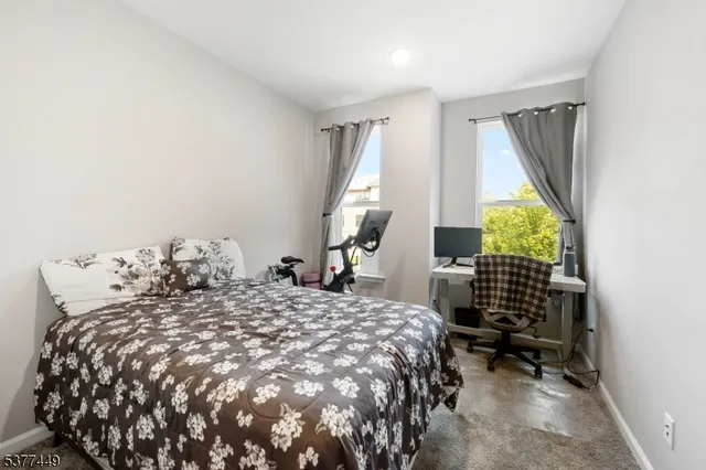 a bed sitting in a bedroom next to a window