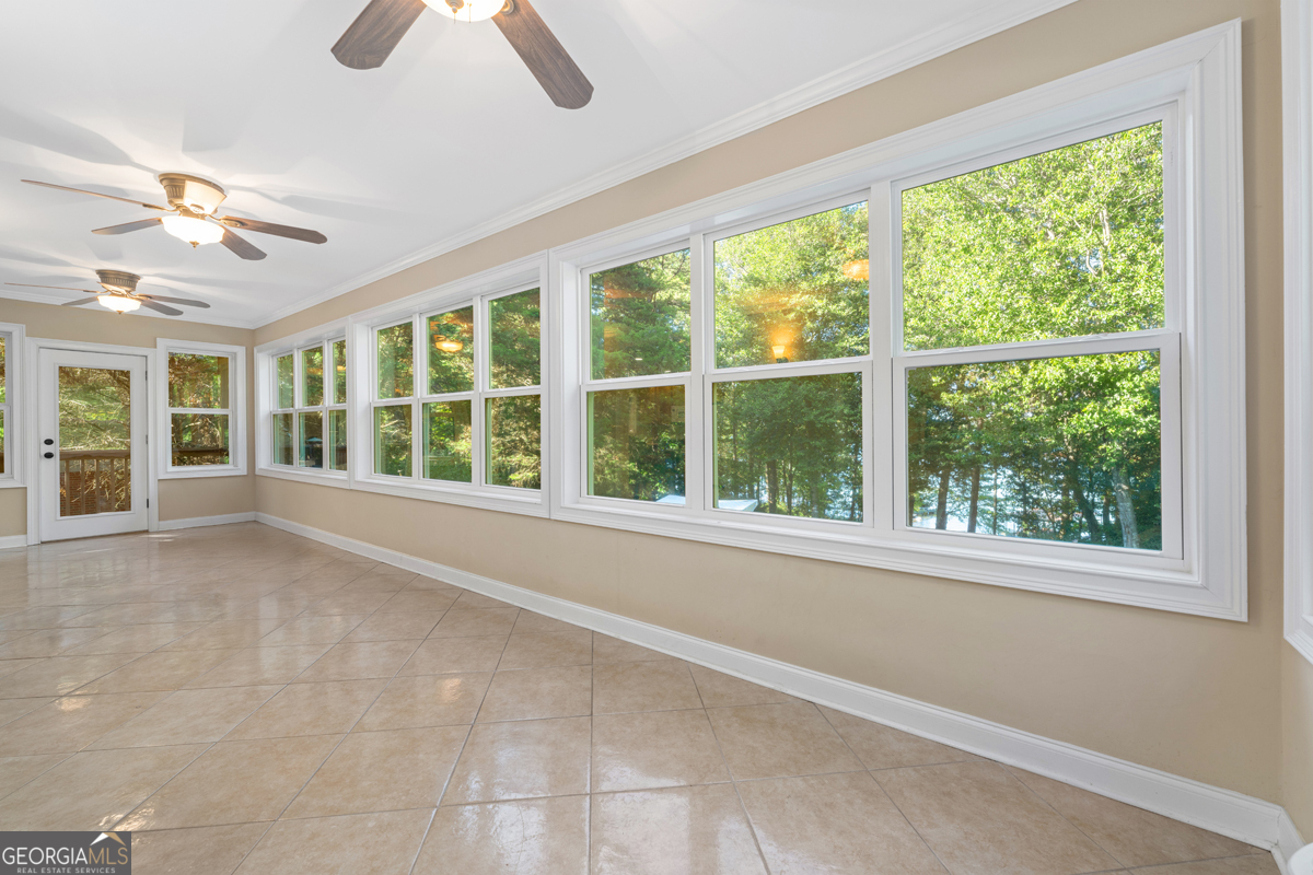 122 Hodges Lane Hartwell, GA 30643 - Photo 27 of 37 a view of an empty room with chandelier fan and fire place