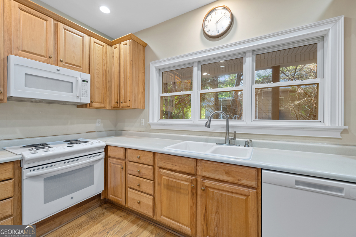 122 Hodges Lane Hartwell, GA 30643 - Photo 30 of 37 a kitchen with stainless steel appliances granite countertop a sink and a stove next to a window