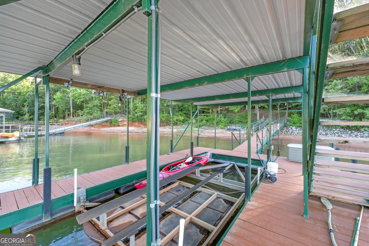 122 Hodges Lane Hartwell, GA 30643 - Photo 7 of 37 a view of deck with a table and chairs under an umbrella