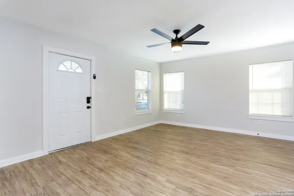 wooden floor in an empty room with a window