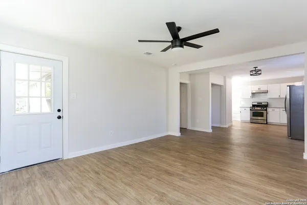 a view of a livingroom with a hardwood floor and a ceiling fan