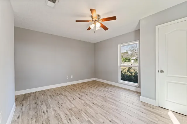 a bathroom with a granite countertop sink a toilet and a shower